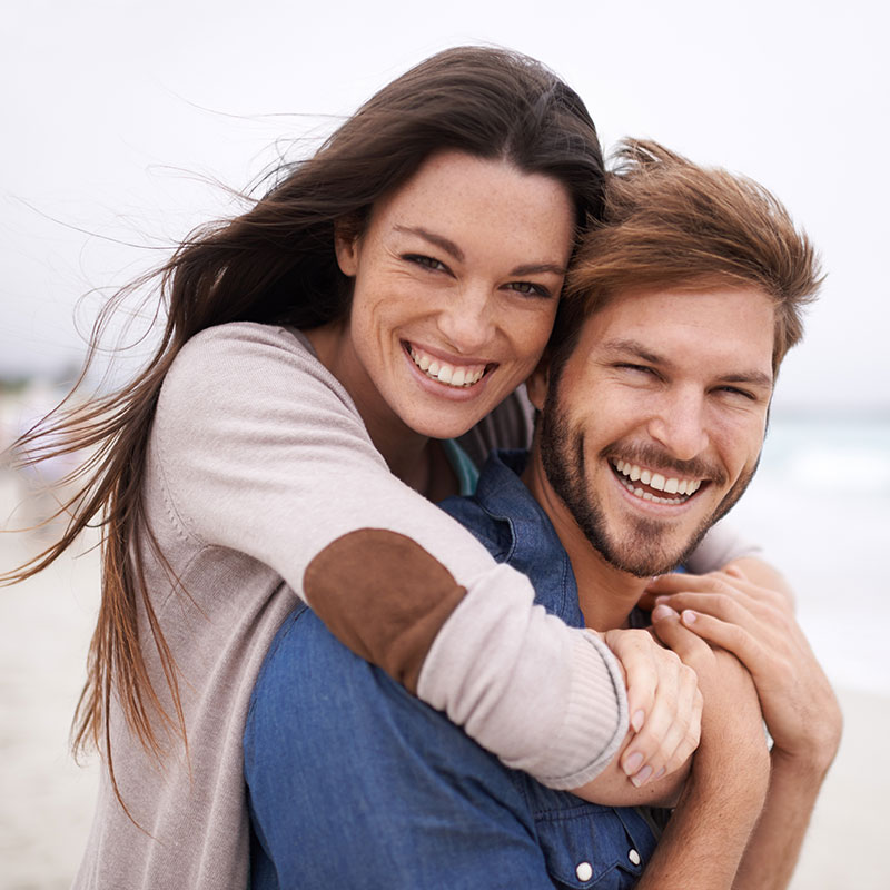 smiling man and woman hugging