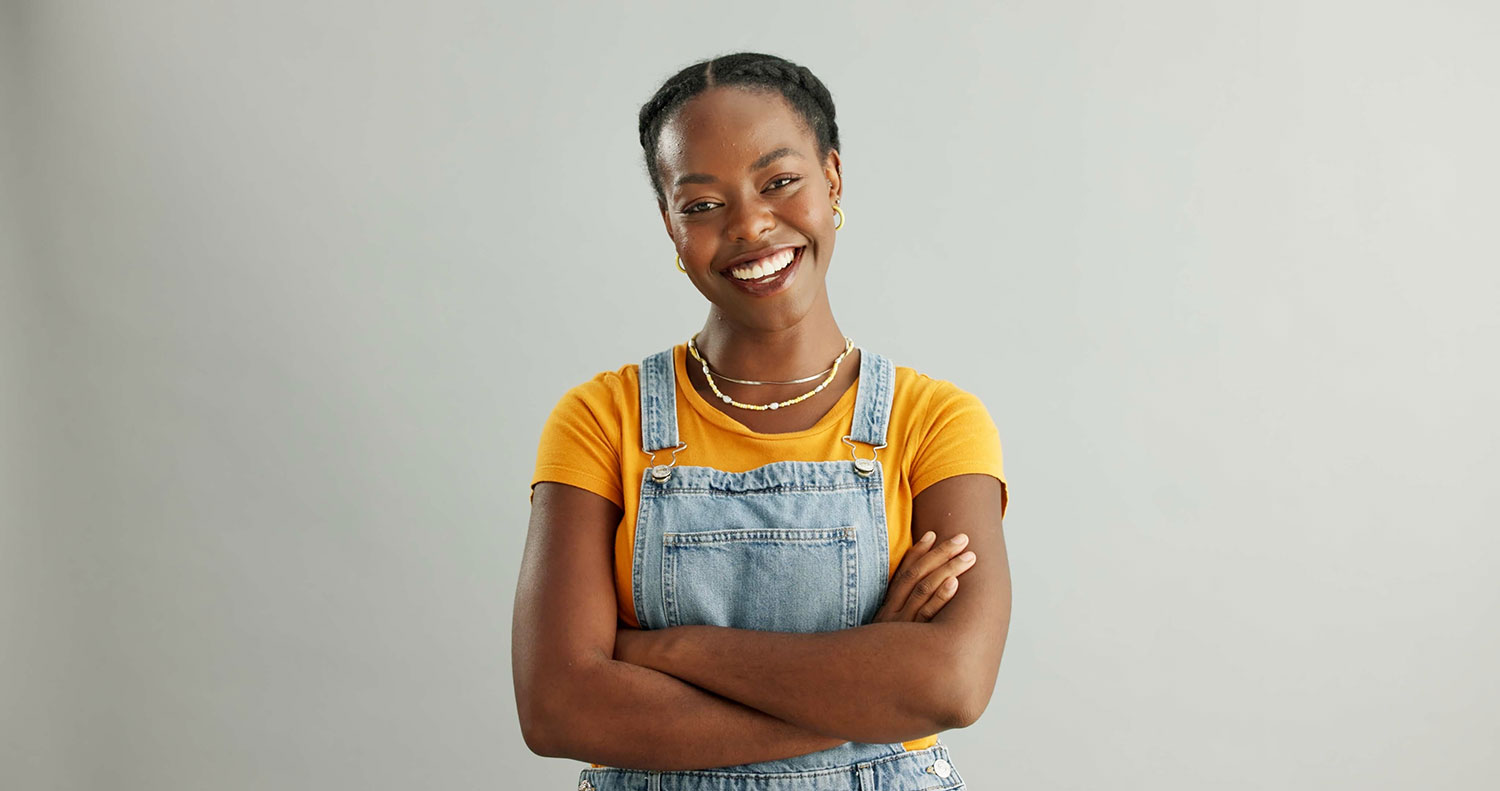 smiling black lady in overalls