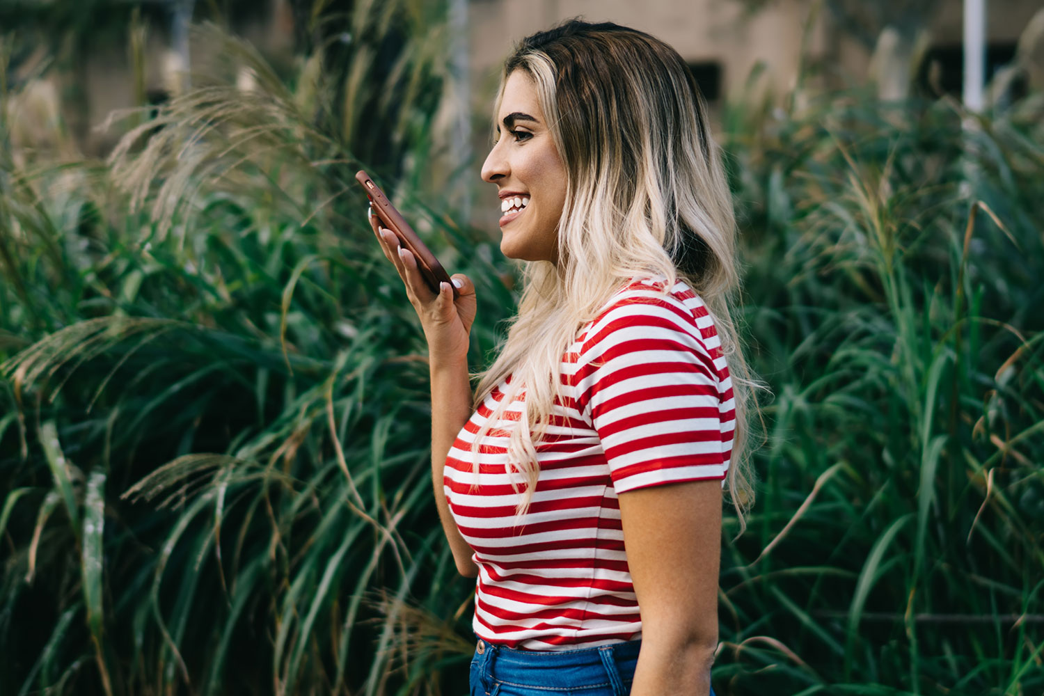 woman in striped shirt talking on phone