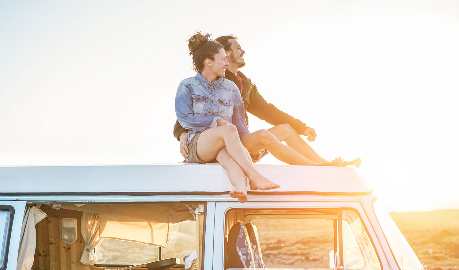couple of top of van looking at sunset